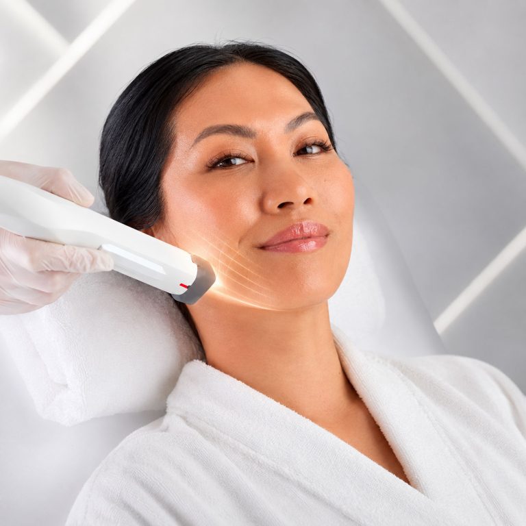 Woman receiving XERF skin tightening treatment on the lower face with a handheld device in a Skin Clinic med spa riverside setting.
